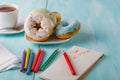 Donuts on table with sketchbook Royalty Free Stock Photo