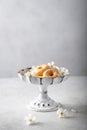 Donuts in a vintage vase with cherry flowers