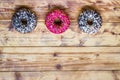 Donuts on wooden background. Sweet foods flat lay with copy space. Food mock up image. Royalty Free Stock Photo