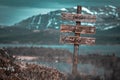 Doom and gloom text quote engraved on wooden signpost outdoors in landscape looking polluted