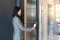 Door access control - young officer woman holding a key card to lock and unlock door for access entry