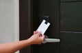 Door access control - young woman holding a key card to lock and unlock door Royalty Free Stock Photo