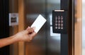 Door access control - young woman holding a key card to lock and unlock door