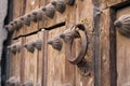 Door with an ancient caller in the medieval Spanish city of Segovia