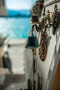 Door bells are sold on the streets of a small town on the island of Greece, the sea is in the background Royalty Free Stock Photo