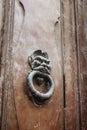 door with a brass knocker in the shape of a man& x27;s head, a beautiful entrance to the house. Wooden door, detail Royalty Free Stock Photo