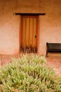 Door and bush at Mission San Miguel Arcangel Royalty Free Stock Photo