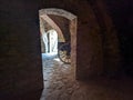 Door, cart, door again and daylight. The view  in the catacombs with old  brick walls Royalty Free Stock Photo