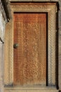 Door with carved hand-made elements, cross, circle Royalty Free Stock Photo