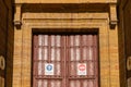 Door of the church of San Isidoro in Oviedo with entry and exit signs on the occasion of Covid.