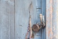 Door closed by retro padlock and blade fixed, fragment of wooden surface, wooden doors, cracked paint, cracks, knuckles, nails, te Royalty Free Stock Photo
