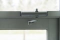 Door Closer on Glass door on building entrace Royalty Free Stock Photo