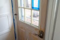Door covered in white painting primer and painters tape during home renovations and painting