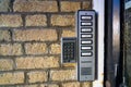 Door entry system and buzzers for each flat on a brick wall. Royalty Free Stock Photo