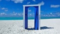 The door is fortunately open. Sunny day, on the white sand of the beach is a blue open door