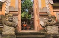 Door or gate to enter into traditional balinese garden lanscaping detail with statues Royalty Free Stock Photo