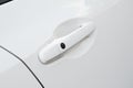 Door handle close-up of a white modern car. Royalty Free Stock Photo