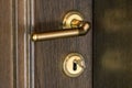 Door handle. Door lock with keys. Brown wooden door closeup. Ne Royalty Free Stock Photo