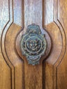 Door handle like antique head on the entrance of a house on Malta. Italian traditional doorknob. Royalty Free Stock Photo