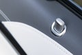 Door handle with lock control buttons of a luxury passenger car. Black leather interior of the luxury modern car. Modern car Royalty Free Stock Photo