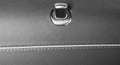 Door handle with lock control buttons of a luxury passenger car. Brown leather interior of the luxury modern car. Modern car inter