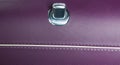 Door handle with lock control buttons of a luxury passenger car. Brown leather interior of the luxury modern car. Modern car inter