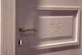 Door handle on modern entrance door closeup background. White scandinavian style fashionable classic design