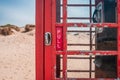 Door handle of an old British red telephone box on a sandy beach in Studland, near Sandbanks, Dorset, UK Royalty Free Stock Photo