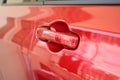 door handle of red car, transportation industry