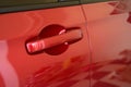 door handle of red car, transportation industry