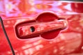 door handle of red car, transportation industry