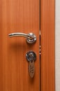 Door handles and key in keyhole Royalty Free Stock Photo