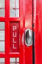 Door hanger and Pull sign on a telephone cabin, London Royalty Free Stock Photo