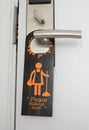 Door of hotel room with please make up room sign hang on door knob Royalty Free Stock Photo