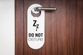 Door of hotel room with sign do not disturb