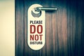 Door of hotel room with sign do not disturb - retro style Royalty Free Stock Photo