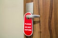 Door of hotel room with sign please do not disturb. Royalty Free Stock Photo