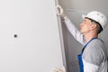 Door installation worker installs security hardware on the door mechanism