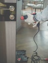 A door installer at work a carpenter drilling a door lock a handyman repairing an interior door. Home worker.