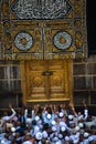 The door of the Kaaba - Multazam. Muslim pilgrims in motion in front of the door of the holy Kaaba