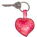 Door key on pink heart shaped key fob cutout Royalty Free Stock Photo