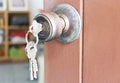 Door knob and key chain on the old wooden door Royalty Free Stock Photo