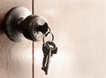 Door knob and key chain on the old wooden door Royalty Free Stock Photo