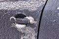 Door, knob, keyhole of car covered with snow and ice after a snowfall Royalty Free Stock Photo