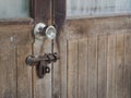 Door knob and old rust padlock key on wooden door Royalty Free Stock Photo