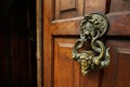 Door knocker in the form of a face on a wooden door in Bran Dracula castle entrance. Transylvania,Romania,Europe Royalty Free Stock Photo