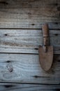 Door knocker in the shape of a garden trowel on old wooden door grainy wood & nails ,background gardening with room for text Royalty Free Stock Photo