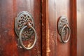 Door knockers made of two iron rings on an antique door. Royalty Free Stock Photo