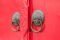 Door knockers on the red door Royalty Free Stock Photo