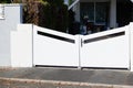 Door large metal gate white fence on home suburb street access house garden Royalty Free Stock Photo